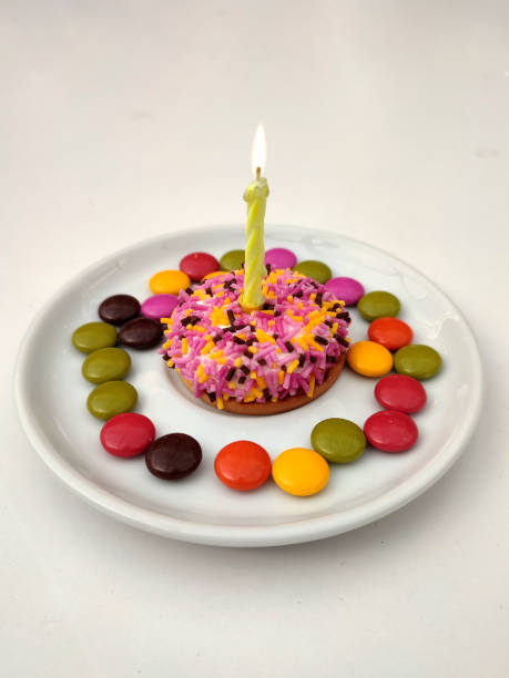 Extreme close up shot of various candies and sweets on a bright pink background.
