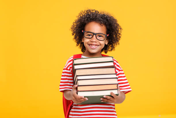 istock Excited ethnic schoolboy with  books laughing 1423600805