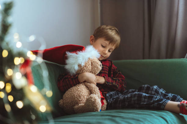 istock cute little boy dressing up teddy bear 1423602175