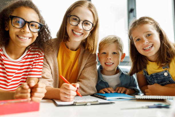 istock Portrait of teacher and students during lesson 1423603967