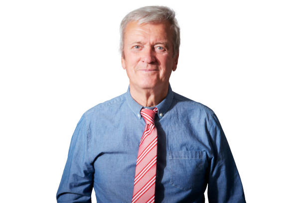 Studio portrait of senior businessman standing at isolated white background.