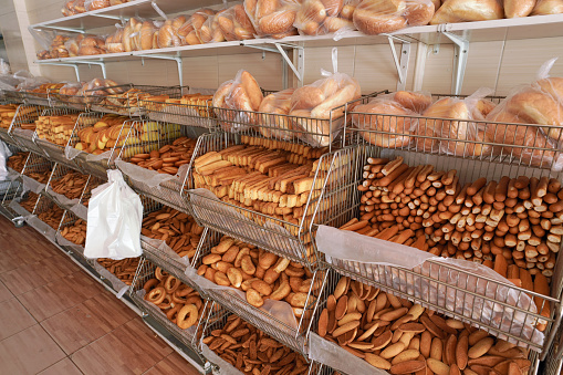 Various pastry and baked dough products in shelves displayed at typical Jordanian bakery