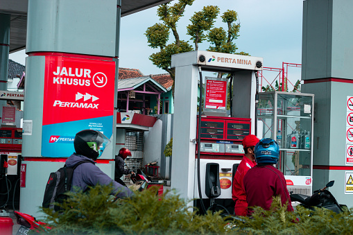 Bandung, Indonesia - September 10, 2022 : Queue of motorcyles at public refueling in Kopo area of Bandung after Petralite price increased