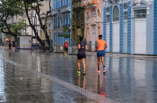 Recife, Pernambuco, Brazil - September 07/2022:People exercising in Rio Branco avenue in a rain, in morning day.