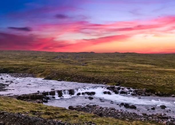 Fantastic landscape with flowing rivers and streams with rocks and grass in Iceland.