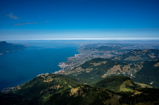 Landscape of lake, mountain and city. Rochers de Naye, Montreux, Switzerland. View from the top of mountain towards Lake Geneva and Montreux city in summer.