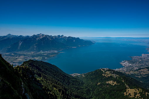 Landscape of lake, mountain and city. Rochers de Naye, Montreux, Switzerland. View from the top of mountain towards Lake Geneva and Montreux city in summer.