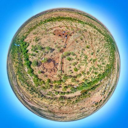 Kalkaringi, Northern Territory, Australia - August 26, 2022: Aerial view of the Freedom Day Festival ceremony site in the township of Kalkaringi\n\nKalkarindji is a community on the land formerly held under the Wave Hill Cattle Station. In 1966, the Aboriginal station workers, led by Vincent Lingiari, staged the Gurindji strike, also known as the Wave Hill Walk Off, in protest against oppressive labour practices and land dispossession. In their honour, we gather on Gurindji Country every August to commemorate and celebrate at the Gurindji Freedom Day Festival. \n\nThe festival is delivered by the Gurindji Aboriginal Corporation, and this iconic event helps to keep Gurindji culture and the Gurindji story alive. Part of the festival re-creates the famous Walk-off. Together, we walk in solidarity with our flags. Beginning at the Art Centre and finishing at the river ceremony site.