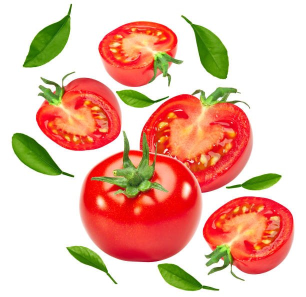 istock flying sliced fresh tomato with green leaves isolated on white background. clipping path 1423610974