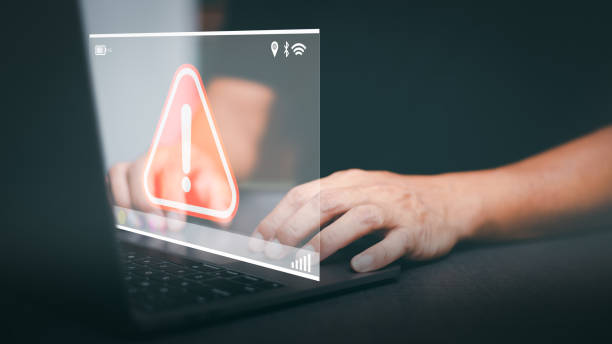 istock Businessman working on laptop computer, exclamation mark, alarm, warning, computer virus detected, danger warning concept or information error that should be urgently fixed and repaired. 1423614332