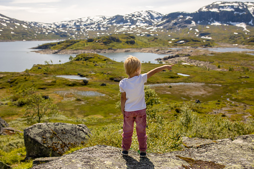 People, children enjoying the amazing views in Norway to fjords, mountains and other beautiful nature miracles