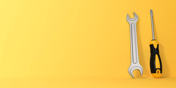 istock Wrench and Screwdriver on a yellow background with copy space 1423619937