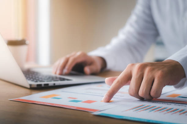 istock Businessman analyzing company's financial balance sheet working with digital augmented reality graphics. Businessman calculates financial data for long-term investment. 1423621860