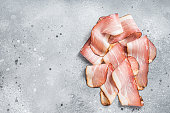 Black Forest Ham Slices on kitchen table. Gray background. Top view. Copy space