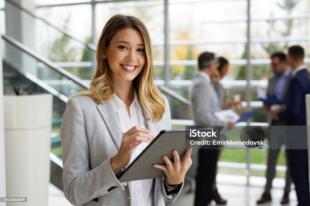 Young businesswoman with digital tablet at work Businesswoman Stock Photo