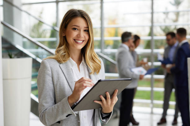 Young businesswoman with digital tablet at work stock photo