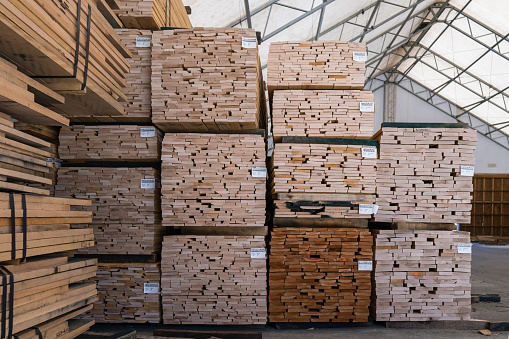 Kingston, NH, US-March 12, 2021: Stacks of lumber on a rack for sale to consumers at a retail hardwood lumber business