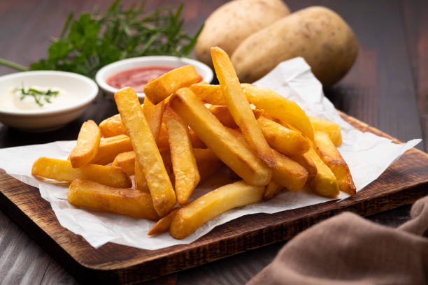istock French fries,fried slice potatoes on paper 1423624570