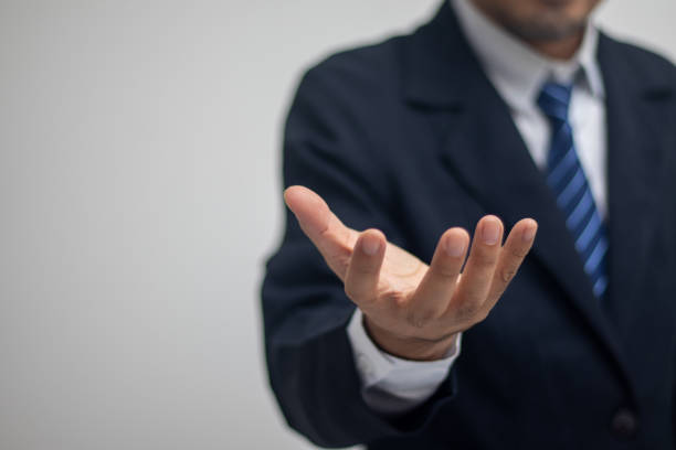 istock Businessman extending his hand, spreading his hand up 1423625758