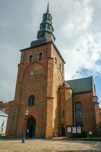 Ystad, Sweden 13 Sep, 2022: Older church building with a clock and spire