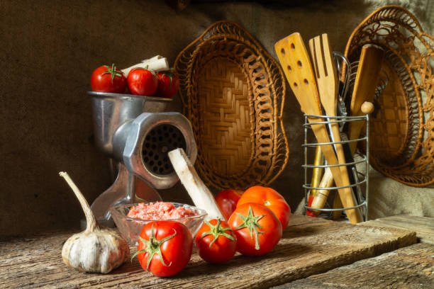 istock Meat grinder with vegetables on the background of kitchen utensils 1423626556