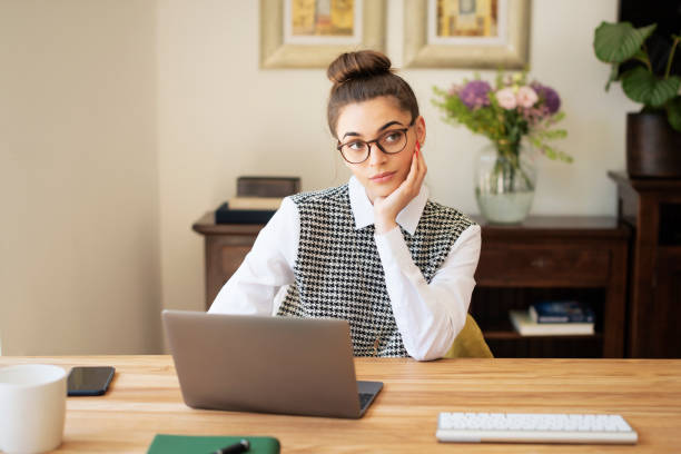 istock Daydreaming woman using her laptop while working from home 1423627141
