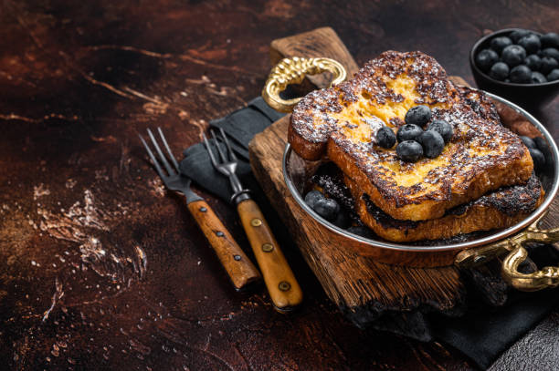 istock French toasts with maple sirup and Blueberry. Dark background. Top view. Copy space 1423629111