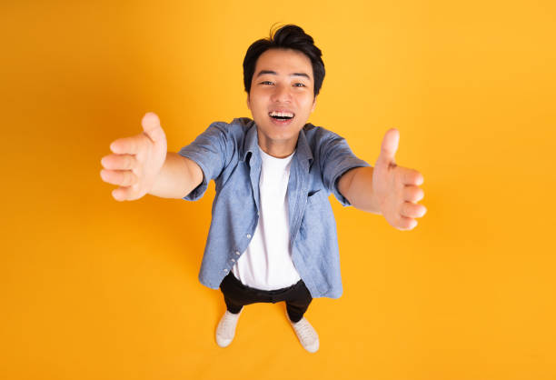 istock image of asian man posing on a yellow background 1423630905
