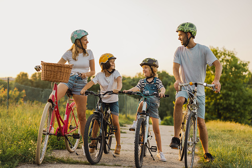 Happy family cycling together in the countryside