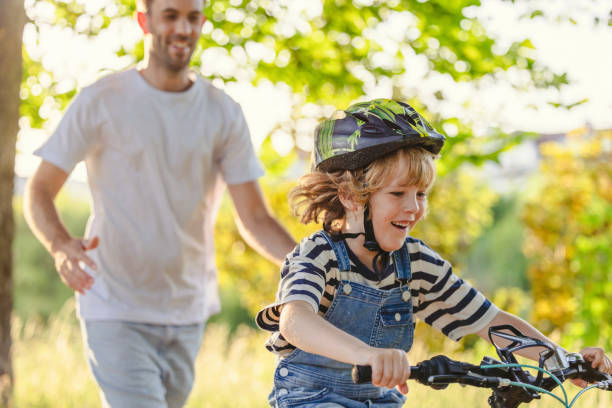 istock Father teaching his son how to ride a bicycle 1423632537