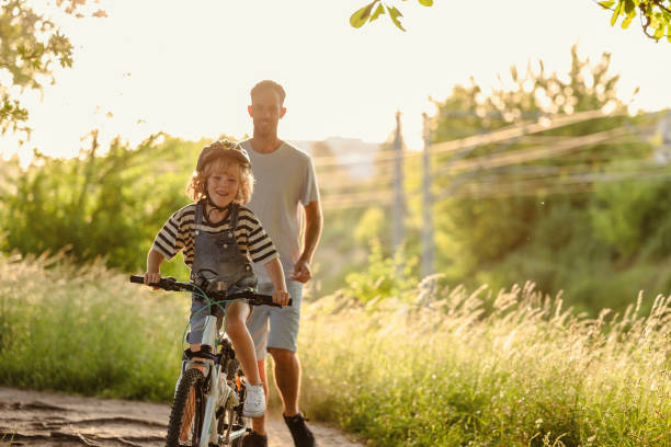 Father teaching his son how to ride a bicycle