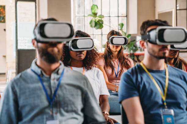istock Group of people wearing virtual reality VR glasses during a virtual meeting 1423632891