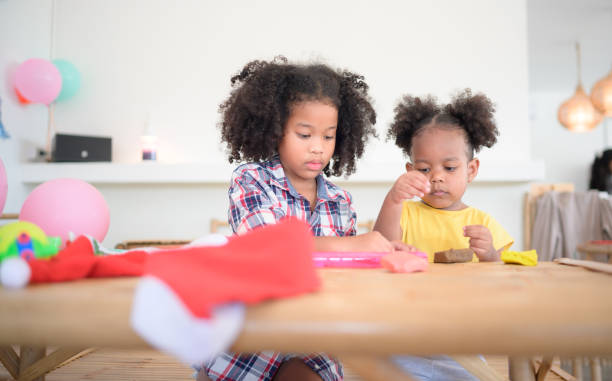 istock Two little girls Playing with plasticine 1423633660