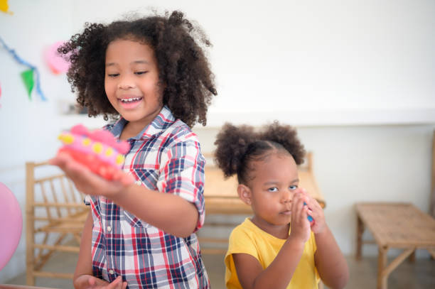 istock Two little girls Playing with plasticine 1423633679