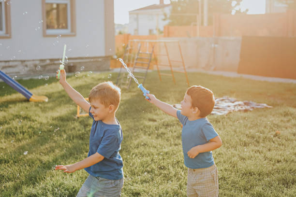 istock Children blow bubbles in the backyard. 1423634127
