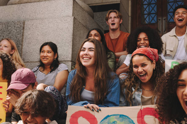 istock Happy youth activists holding a climate change demonstration 1423636013