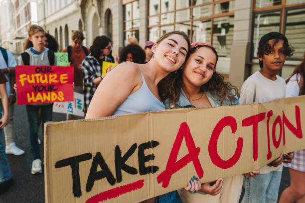 istock Teenagers marching against climate change and global warming 1423636646