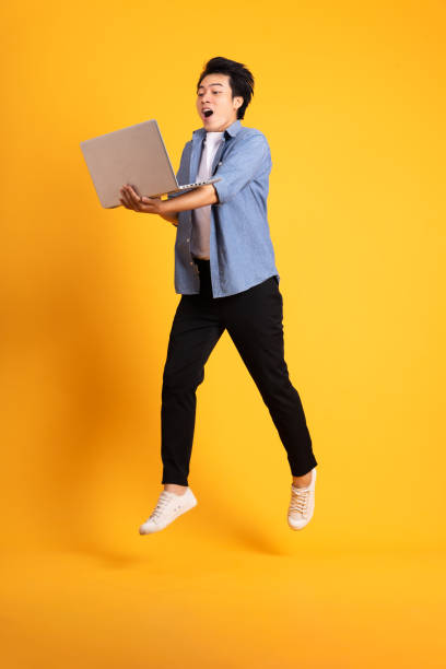istock full body image of asian man posing on yellow background 1423637384