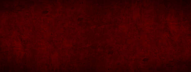 istock Abstract old aged damaged cracked grunge dark red colored concrete cement plaster facade wall texture colorful background banner panorama wide pattern 1423637759