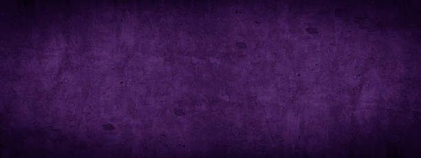 istock Abstract old aged damaged cracked grunge purple colored concrete cement plaster facade wall texture colorful background banner panorama wide pattern 1423637762
