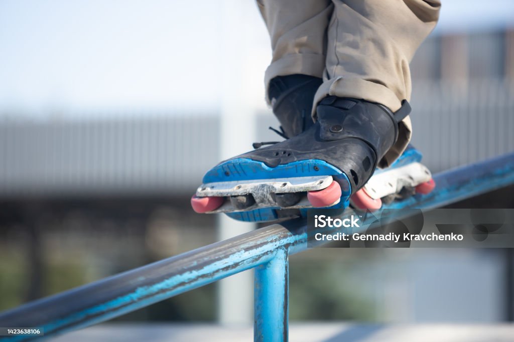 Inline Skater Grinds On Rail In Skatepark Roller Blader Grinding