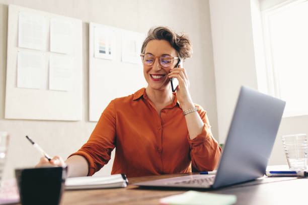 istock Happy interior designer speaking with a client on the phone 1423638498