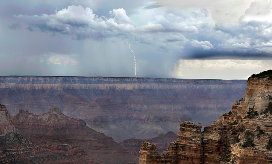 A single bolt of lighning strikes along the south rim of the Grand Canyon at Grand Canyon National park, Arizona.