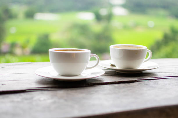 Coffee Cup on Table Against Landscape Scenery Mountain Hill Background close-up photo