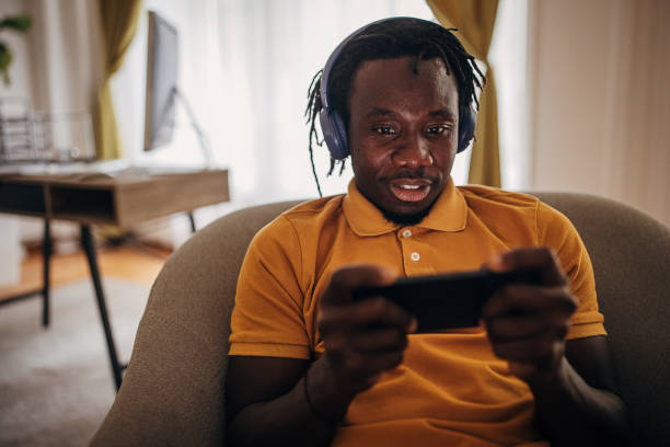 istock Man playing games on phone 1423642194