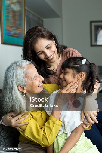 istock Happy woman with grandmother embracing granddaughter 1423642429