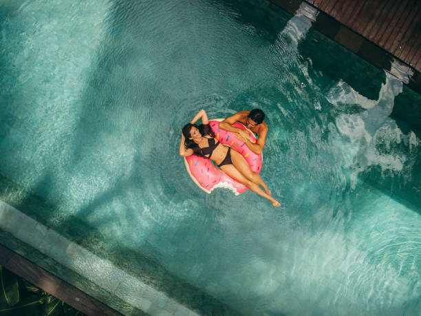 istock Couple enjoying vacation in resort pool 1423642555