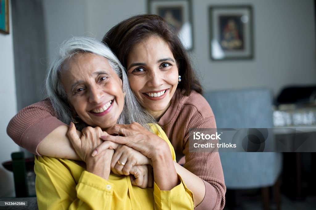 Happy woman with mother Happy woman spending leisure time with her mother at home Senior Adult Stock Photo