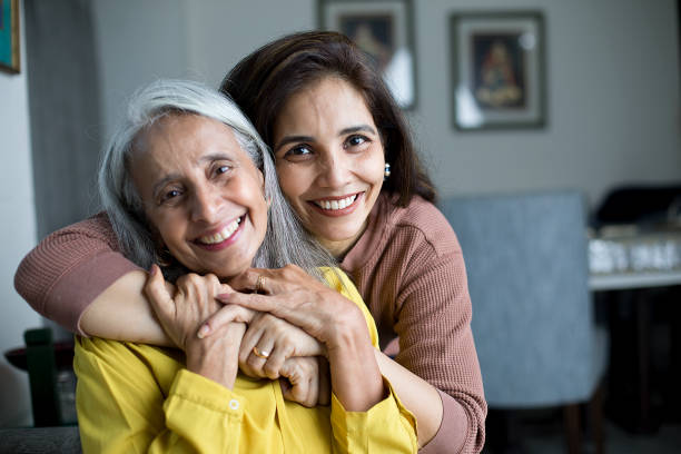 Happy woman with mother Happy woman spending leisure time with her mother at home adult offspring stock pictures, royalty-free photos & images