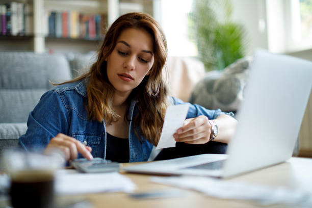 istock Woman paying her utility bills online 1423646103